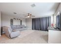 Bright living room featuring a sectional sofa and access to a backyard patio at 29362 W Weldon Ave, Buckeye, AZ 85396