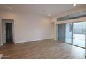 Spacious living room with neutral paint, tile floors, and sliding glass doors to the backyard at 32496 N 135Th Dr, Peoria, AZ 85383