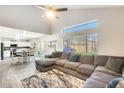 Spacious living room with L-shaped sectional sofa and view of kitchen at 3610 N 106Th Ave, Avondale, AZ 85392