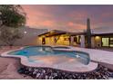 Freeform pool and spa with a modern design in the backyard at 4314 E Forest Pleasant Pl, Cave Creek, AZ 85331