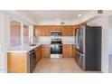 Well-equipped kitchen featuring stainless steel appliances and wood cabinets at 4622 W Desert Crest Dr, Glendale, AZ 85301