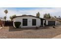 White single story home with a gray garage door and neatly landscaped front yard at 4639 W Becker Ln, Glendale, AZ 85304