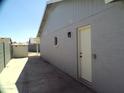 Side yard with a concrete patio and access gate at 5843 W Crocus Dr, Glendale, AZ 85306