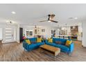 Open living room with blue couches and wood flooring at 5960 E Pershing Ave, Scottsdale, AZ 85254