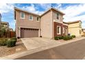 Rear view of the house showcasing garage and landscaping at 646 S Jacana Ln, Gilbert, AZ 85296