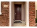 Dark brown front door with a plaid welcome mat at 646 S Jacana Ln, Gilbert, AZ 85296