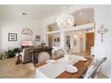 Bright dining room with chandelier and spacious layout adjoining living area at 7167 W Trails Dr, Glendale, AZ 85308