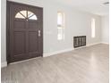 Entryway with tile floors, fireplace, and dark door at 7736 W Acoma Dr, Peoria, AZ 85381