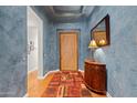 Elegant foyer with wood flooring and a unique textured wall at 8760 N 73Rd Way, Scottsdale, AZ 85258