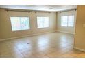 Spacious living room with large windows and tile floor at 9655 E Edgewood Ave, Mesa, AZ 85208