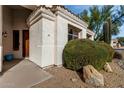 Front entrance with a wooden door and landscaping at 9880 E Pine Valley Rd, Scottsdale, AZ 85260