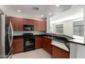 Modern kitchen featuring dark wood cabinets and granite countertops at 11640 N Tatum Blvd # 2079, Phoenix, AZ 85028