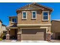 Tan two-story house with stone accents, landscaping, and a two-car garage at 1333 N Balboa --, Mesa, AZ 85205