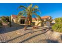 Charming one-story house with a palm tree and gravel yard at 14328 W Dusty Trail Blvd, Sun City West, AZ 85375