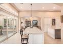 Bright kitchen with island seating and views to the backyard at 1534 E Sweet Citrus Dr, Queen Creek, AZ 85140