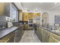 Modern kitchen with gold cabinets and expansive countertop at 15831 E Thistle Dr, Fountain Hills, AZ 85268