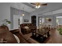 Spacious living room with leather sofas and a built-in bookshelf at 1570 W Bartlett Way, Chandler, AZ 85248