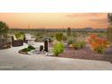 Landscaped backyard oasis with mountain views and water feature at 17676 E Woolsey Way, Rio Verde, AZ 85263