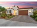 Single story home with Spanish-style architecture, landscaping, and a two-car garage at 20363 W Coolidge St, Buckeye, AZ 85396