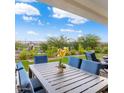 Relaxing covered patio with stylish outdoor furniture and a view of the manicured backyard at 20363 W Coolidge St, Buckeye, AZ 85396