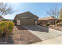 Single story home with a two-car garage and gravel driveway at 2185 E Hazeltine Way, Gilbert, AZ 85298