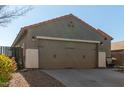 Two-car garage and front entry of a single story home at 2185 E Hazeltine Way, Gilbert, AZ 85298