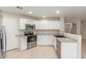 Bright kitchen featuring stainless steel appliances and white cabinets at 2298 E Hazeltine Way, Chandler, AZ 85249