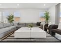 Bright living room featuring a comfortable gray sectional and modern decor at 2324 W Moody Trl, Phoenix, AZ 85041