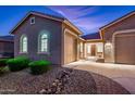 Two-car garage, well-lit entrance and nicely landscaped front yard at 24018 N 165Th Dr, Surprise, AZ 85387