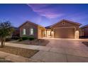 Attractive single-story home with a two-car garage and landscaped front yard at 24018 N 165Th Dr, Surprise, AZ 85387