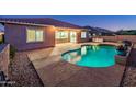 Stunning pool and patio area at dusk at 24018 N 165Th Dr, Surprise, AZ 85387