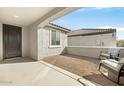 Covered patio with brick flooring and rocking chairs at 26448 W Kimberly Way, Buckeye, AZ 85396