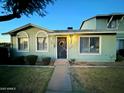 Charming light green single story home with a well manicured lawn at 2645 W Wolf St, Phoenix, AZ 85017