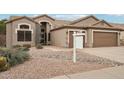 Home exterior with a two-car garage and a pool at 26616 N 42Nd Way, Cave Creek, AZ 85331