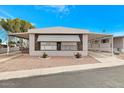 Inviting manufactured home with covered carport and landscaping at 305 S Val Vista Dr # 125, Mesa, AZ 85204