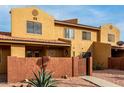 Attractive two-story stucco home with a gated entry and walkway at 3511 E Baseline Rd # 1203, Phoenix, AZ 85042