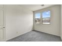 Bright bedroom with gray carpet and two large windows at 37549 W San Clemente St, Maricopa, AZ 85138