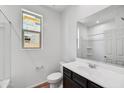 Clean bathroom with dark vanity and a large mirror at 37550 W San Clemente St, Maricopa, AZ 85138