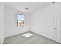 Bright bedroom with neutral carpeting and large window at 37550 W San Clemente St, Maricopa, AZ 85138