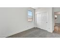 Spacious bedroom with neutral carpeting and sliding door at 37551 W Patterson St, Maricopa, AZ 85138