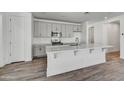 Modern kitchen featuring gray cabinets, white countertops, and stainless steel appliances at 37566 W San Clemente St, Maricopa, AZ 85138