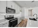 Modern kitchen with gray cabinets, white quartz countertops and stainless steel appliances at 37566 W San Clemente St, Maricopa, AZ 85138