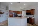 Spacious kitchen with dark wood cabinets, stainless steel appliances, and a breakfast bar at 4119 E Barwick Dr, Cave Creek, AZ 85331