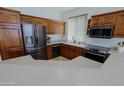 Modern kitchen featuring dark wood cabinets and stainless steel appliances at 4119 E Barwick Dr, Cave Creek, AZ 85331