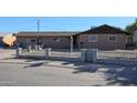 Ranch style home with a well-maintained front yard, featuring a small fence at 4131 N 55Th Dr, Phoenix, AZ 85031