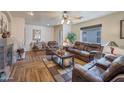 Relaxing living room with fireplace and leather furniture at 43568 W Bedford Dr, Maricopa, AZ 85138