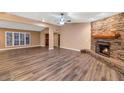 Living room with stone fireplace and hardwood floors at 437 E Marconi Ave, Phoenix, AZ 85022