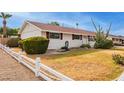 White brick ranch home with a spacious front lawn at 501 W Linda Ln, Chandler, AZ 85225