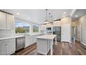 Modern kitchen featuring white cabinets, island, and stainless steel appliances at 5089 E 26Th Ave, Apache Junction, AZ 85119