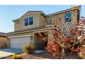 Two-story house with beige exterior, two-car garage, and landscaping at 5656 N 109Th Ave, Phoenix, AZ 85037